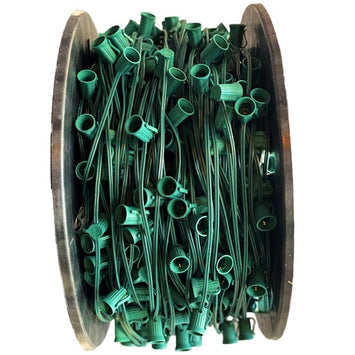 A spool of green Christmas light sockets designed for C9 LED bulbs.