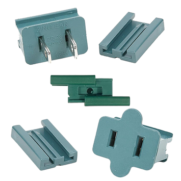 A set of green male (pronged) slide plugs in various orientations, showing the details of the plug's structure and a wire connection point.
