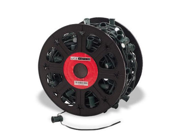 A spool of green wire with C9 sockets spaced 12 inches apart, designed for holiday lighting.