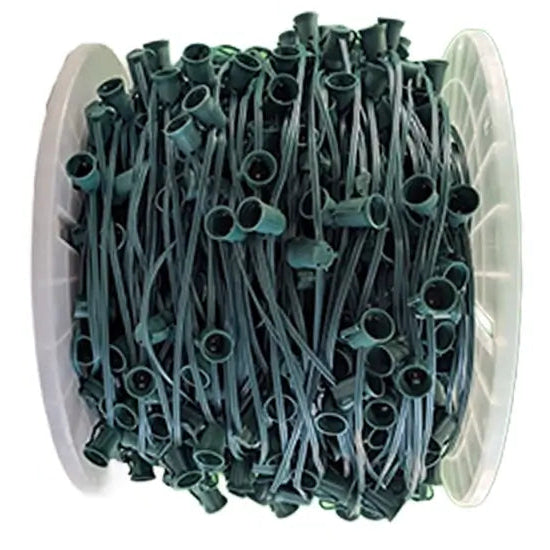 Spool of green garden hose with connectors on a white background